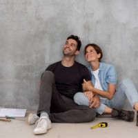 happy couple taking a break from building their house - home decoration stock pictures, royalty-free photos & images