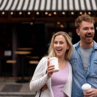 happy couple taking a cup of coffee on-the-go - junk food stock pictures, royalty-free photos & images
