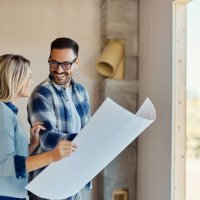 happy couple talking about blueprints of their developing house. - home decoration stock pictures, royalty-free photos & images