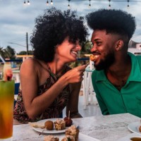 happy couple talking and eating on a restaurant - food stock pictures, royalty-free photos & images