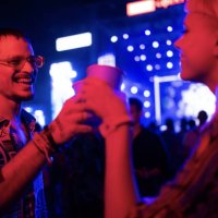 happy couple toasting during a music concert at night. - concert stock pictures, royalty-free photos & images
