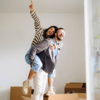 happy couple with arms stretched out enjoying in new home - home decoration stock pictures, royalty-free photos & images