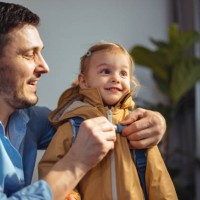 happy dad getting his daughter ready to go outside - junk food stock pictures, royalty-free photos & images