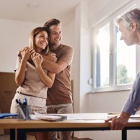 happy embraced couple talking about blueprints with an architect. - home decoration stock pictures, royalty-free photos & images