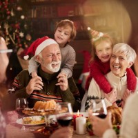 happy extended family enjoying on christmas in dining room. - food stock pictures, royalty-free photos & images