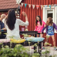 happy family and friends watching girls dancing in back yard during garden party - garden decoration stock pictures, royalty-free photos & images