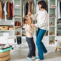 happy family of mom and daughter have fun and dance together at home in a bedroom near the closet - fashion stock pictures, royalty-free photos & images