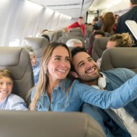 happy family traveling by plane and taking a selfie - travel stock pictures, royalty-free photos & images