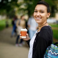 happy female college student outdoors - junk food stock pictures, royalty-free photos & images