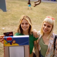 happy female friends buying drinks on a music festival. - concert stock pictures, royalty-free photos & images
