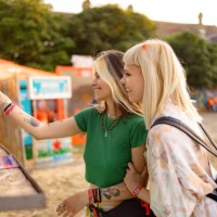 happy female friends buying drinks with contactless payment on music festival. - concert stock pictures, royalty-free photos & images