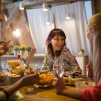happy female friends having dinner at home together - food stock pictures, royalty-free photos & images