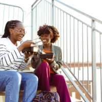 happy female friends on a lunch break - junk food stock pictures, royalty-free photos & images