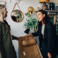 happy female owner talking with customer buying furniture at antique store - home decoration stock pictures, royalty-free photos & images