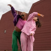 happy friends dancing together in front of building - fashion stock pictures, royalty-free photos & images