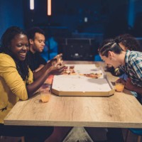 happy friends eating pizza - junk food stock pictures, royalty-free photos & images