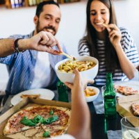 happy friends having french fries and pizza at home - junk food stock pictures, royalty-free photos & images