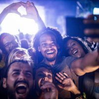 happy friends taking a selfie on music festival by night. - concert stock pictures, royalty-free photos & images