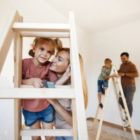 happy girl enjoying with her mother on ladders during home renovation process. - home decoration stock pictures, royalty-free photos & images