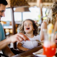 happy girl enjoying with her parents during lunch in a restaurant. - food stock pictures, royalty-free photos & images