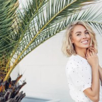 happy girl walking near palm trees on a summer sunny day - fashion stock pictures, royalty-free photos & images