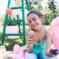 happy girl with ice cream and flamingo float - garden decoration stock pictures, royalty-free photos & images