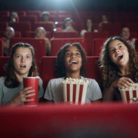 happy girls watching a surprising movie in theatre. - home decoration stock pictures, royalty-free photos & images