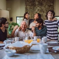 happy grandfather surrounded with his family at breakfast - food stock pictures, royalty-free photos & images