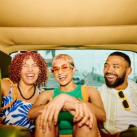 happy group of friends on the back seat of a car, getting away for the weekend. - fashion stock pictures, royalty-free photos & images