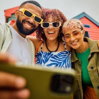 happy group of friends using their smartphone while travelling. - fashion stock pictures, royalty-free photos & images