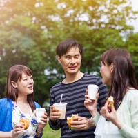 happy group of japanese friends eat in the park, tokyo - junk food stock pictures, royalty-free photos & images