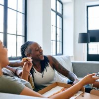 happy lesbian couple watching tv - junk food stock pictures, royalty-free photos & images