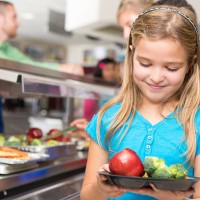 happy little girl making healthy choices in school cafeteria - food stock pictures, royalty-free photos & images