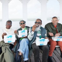 happy male and female friends having fish and chips - junk food stock pictures, royalty-free photos & images