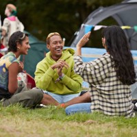 happy man and woman looking at friend gesturing - concert stock pictures, royalty-free photos & images