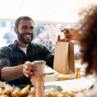 happy man buying take out food at a cafe - food stock pictures, royalty-free photos & images