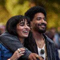 happy man with arm around girlfriend looking away - concert stock pictures, royalty-free photos & images