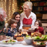 happy mature woman serving dessert to her family after christmas dinner. - food stock pictures, royalty-free photos & images
