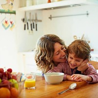 happy mother embracing son having breakfast - food stock pictures, royalty-free photos & images