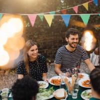 happy multi-ethnic friends enjoying dinner at table during garden party - garden decoration stock pictures, royalty-free photos & images