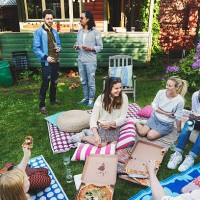 happy multi-ethnic friends having pizza in lawn during summer party - junk food stock pictures, royalty-free photos & images