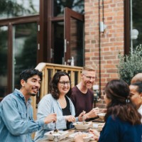 happy multiracial coworkers enjoying lunch together outside cafe - junk food stock pictures, royalty-free photos & images