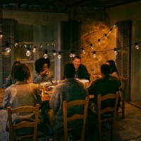 happy multiracial female and male friends sitting at dining table in patio during dinner party at night - garden decoration stock pictures, royalty-free photos & images