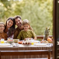 happy parents and their kids having picnic in nature. - garden decoration photos et images de collection