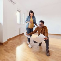 happy pregnant couple analyzing blueprints in their new apartment. - home decoration stock pictures, royalty-free photos & images