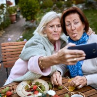 happy senior friends taking a selfie at garden table - garden decoration stock pictures, royalty-free photos & images