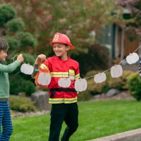 happy siblings celebrating halloween in their front yard - garden decoration stock pictures, royalty-free photos & images