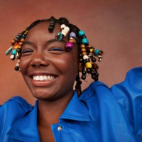 happy teenage girl with beads on braids against brown background - fashion stock pictures, royalty-free photos & images