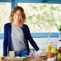 happy woman at breakfast table in kitchen - food stock pictures, royalty-free photos & images