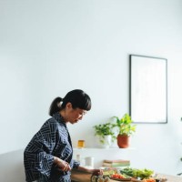 happy woman cutting sushi rolls in the kitchen - home decoration stock pictures, royalty-free photos & images